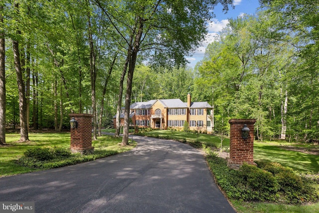 6601 Rutledge Dr, Fairfax Station, VA 22039 - view of front of home featuring a chimney, a front yard, and aphalt driveway
