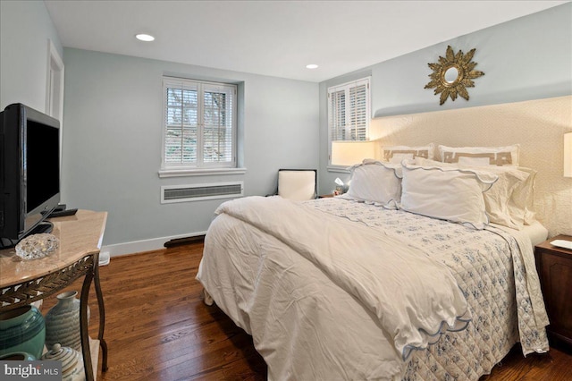 bedroom featuring a wall mounted AC, recessed lighting, baseboards, and wood finished floors