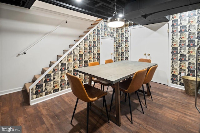 dining space with stairs, baseboards, and wood finished floors