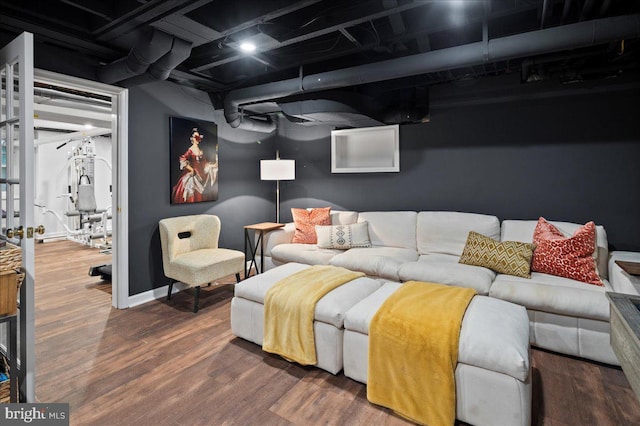 home theater featuring baseboards and wood finished floors