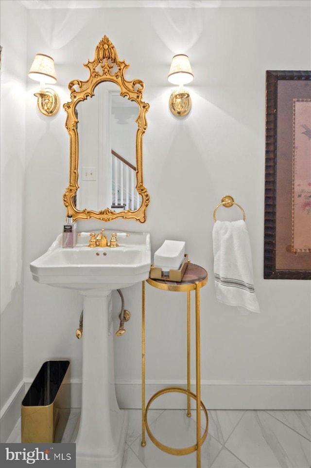 bathroom featuring baseboards and marble finish floor