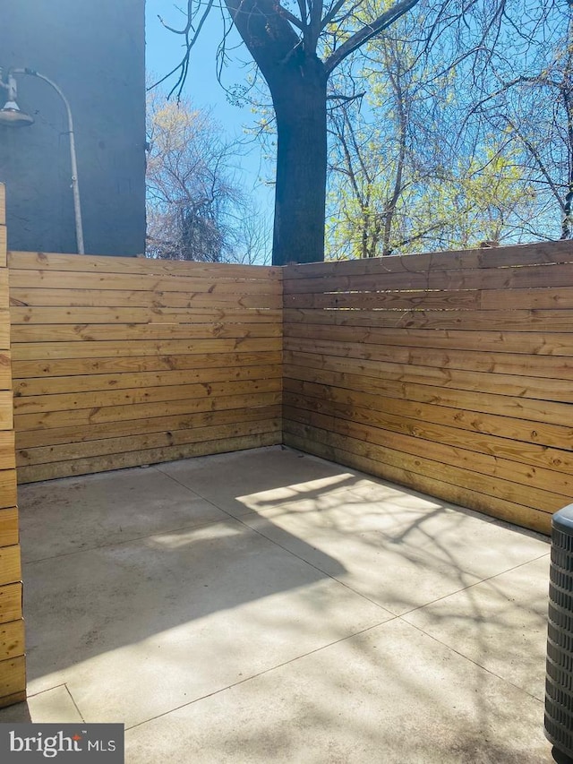 view of patio with fence and central AC
