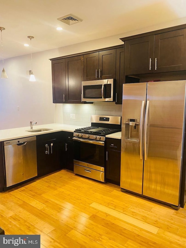 kitchen featuring stainless steel appliances, tasteful backsplash, visible vents, recessed lighting, and light countertops