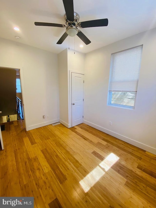 unfurnished bedroom with baseboards, recessed lighting, ceiling fan, and light wood-type flooring