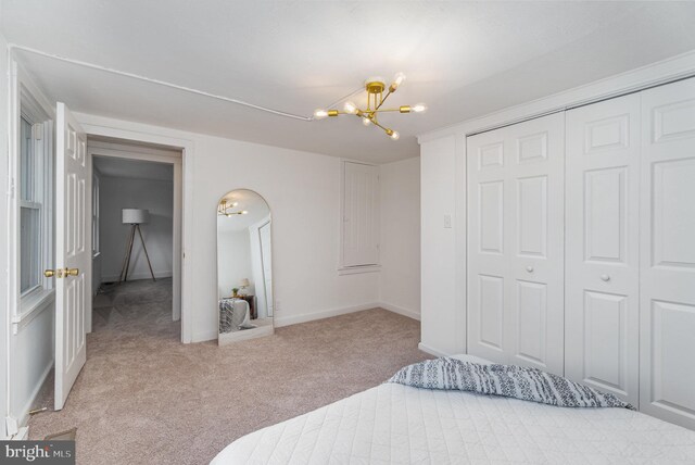 542 E Orange St, Lancaster, PA 17602 - bedroom featuring an inviting chandelier, arched walkways, a closet, carpet floors, and baseboards
