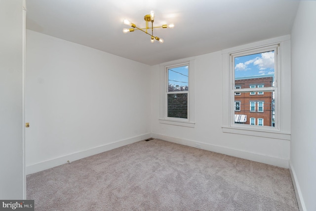 542 E Orange St, Lancaster, PA 17602 - carpeted spare room with baseboards and a chandelier