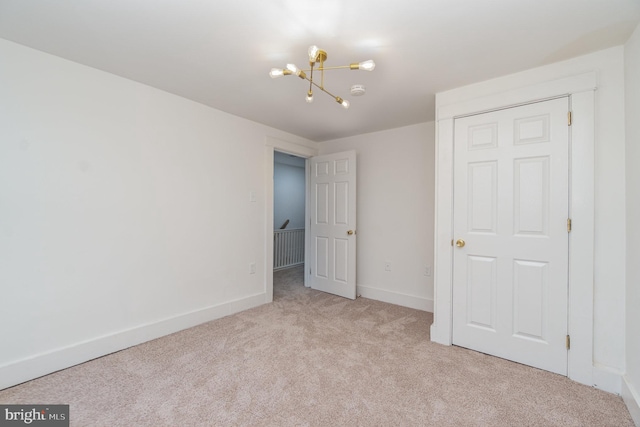 542 E Orange St, Lancaster, PA 17602 - unfurnished bedroom featuring carpet, a chandelier, and baseboards