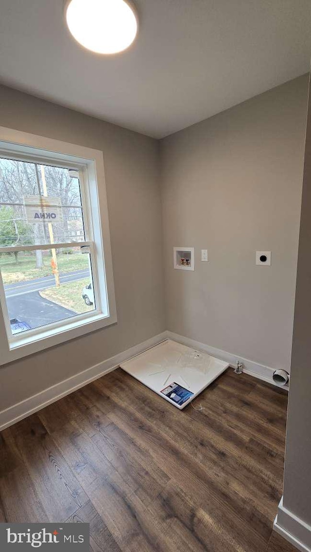 washroom with laundry area, electric dryer hookup, washer hookup, wood-type flooring, and baseboards