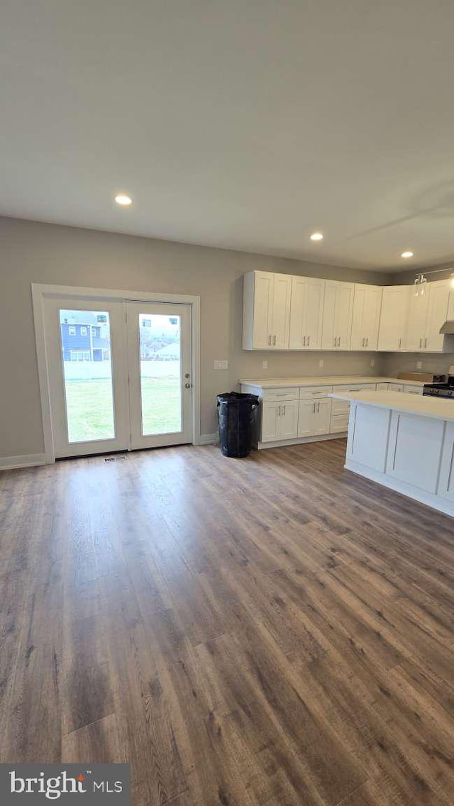 kitchen featuring light countertops, white cabinetry, recessed lighting, and dark wood-style floors