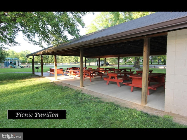 view of home's community with a patio, playground community, and a yard