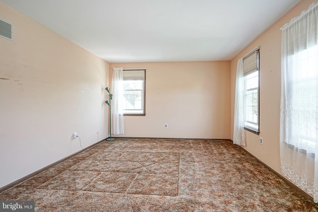 carpeted empty room with visible vents