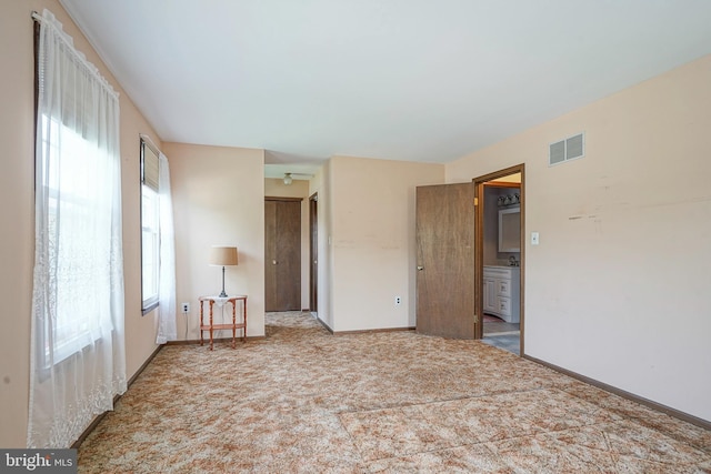 unfurnished bedroom with baseboards, visible vents, and carpet floors