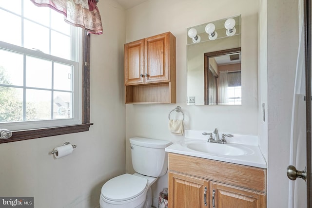 half bath featuring toilet and vanity