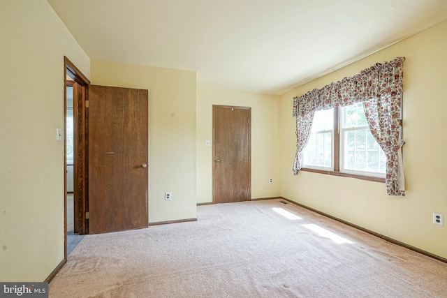 unfurnished bedroom featuring a closet, carpet flooring, and baseboards