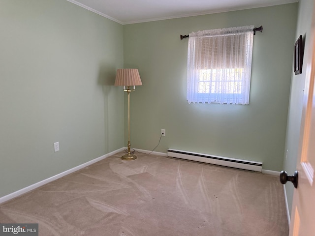 spare room with a baseboard radiator, ornamental molding, carpet flooring, and baseboards