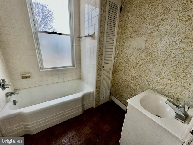 2214 Noble St, Reading, PA 19609 - full bathroom featuring a baseboard heating unit, wallpapered walls, a closet, brick patterned floors, and shower / bathtub combination