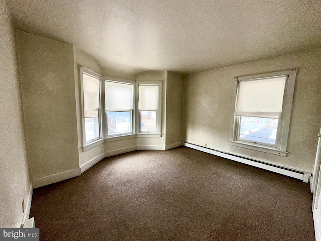 2214 Noble St, Reading, PA 19609 - unfurnished room with a baseboard heating unit, plenty of natural light, dark carpet, baseboards, and a textured ceiling