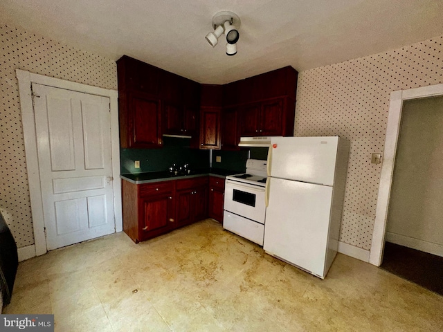 2214 Noble St, Reading, PA 19609 - kitchen with white appliances, dark brown cabinets, under cabinet range hood, wallpapered walls, and a sink