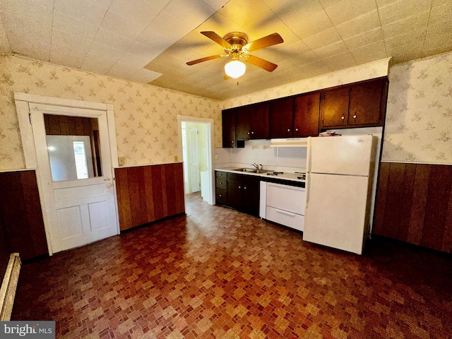 2214 Noble St, Reading, PA 19609 - kitchen with freestanding refrigerator, wallpapered walls, a wainscoted wall, a sink, and ceiling fan