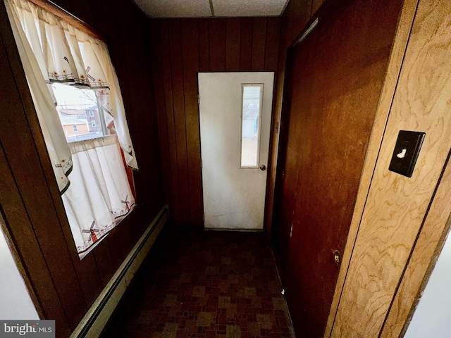 2214 Noble St, Reading, PA 19609 - corridor featuring wood walls and a baseboard heating unit