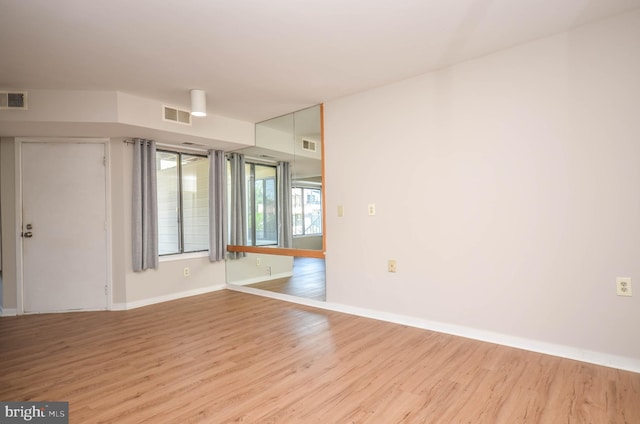 empty room featuring light wood-style floors and baseboards