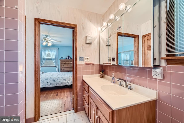1722 Anne Ave, Baltimore, MD 21221 - bathroom with ceiling fan, vanity, ensuite bath, tile walls, and tile patterned floors