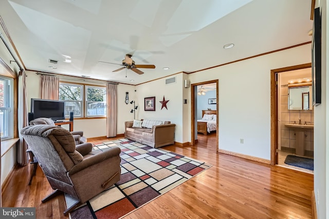 1722 Anne Ave, Baltimore, MD 21221 - living area featuring visible vents, baseboards, ornamental molding, ceiling fan, and wood finished floors