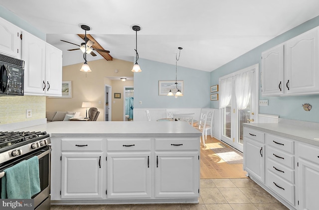 kitchen featuring stainless steel gas range, black microwave, a ceiling fan, a peninsula, and vaulted ceiling with beams