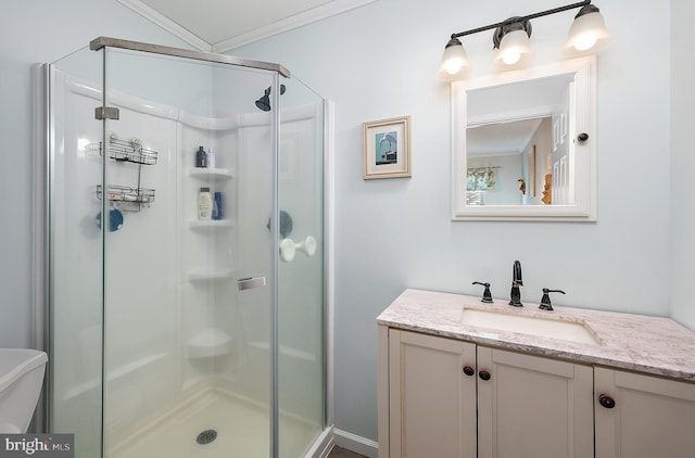 full bathroom with crown molding, vanity, a shower stall, and toilet