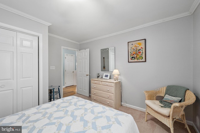 bedroom with crown molding, baseboards, light colored carpet, and a closet