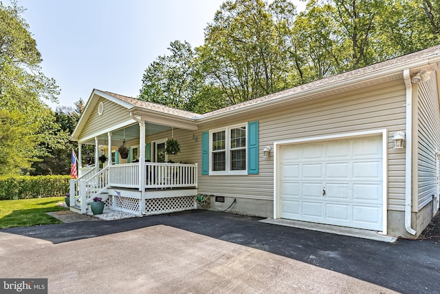 ranch-style house with a porch and driveway