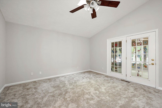 spare room with carpet flooring, a ceiling fan, lofted ceiling, and baseboards