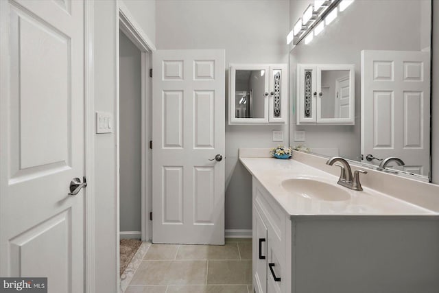 bathroom featuring vanity, tile patterned floors, and baseboards