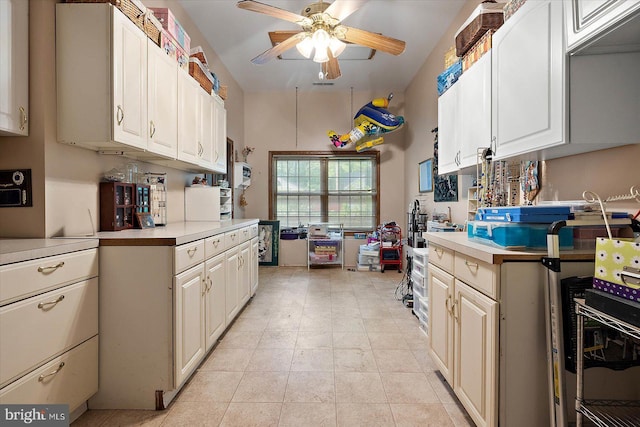 kitchen with a ceiling fan, light countertops, and light tile patterned flooring