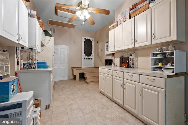 kitchen featuring a ceiling fan, white cabinetry, light countertops, and light tile patterned flooring