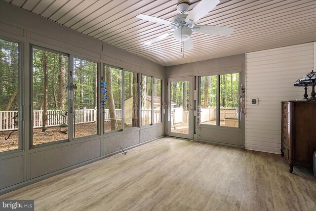 unfurnished sunroom with healthy amount of natural light and a ceiling fan