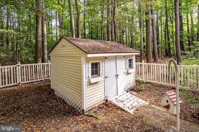 view of shed featuring fence