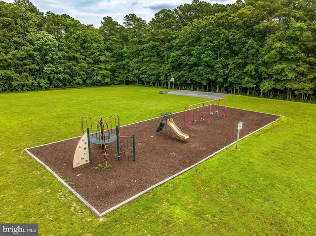 community play area featuring a yard and a forest view