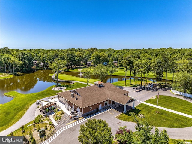 drone / aerial view of a nearby body of water and a golf course