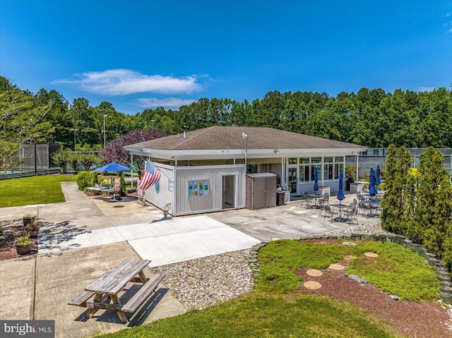 rear view of house featuring a patio and fence