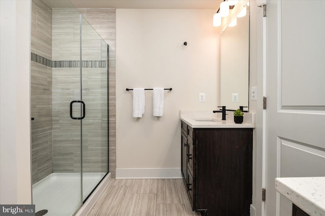 418 S Seaway Ct, Cambridge, MD 21613 - bathroom with a shower stall, baseboards, and vanity