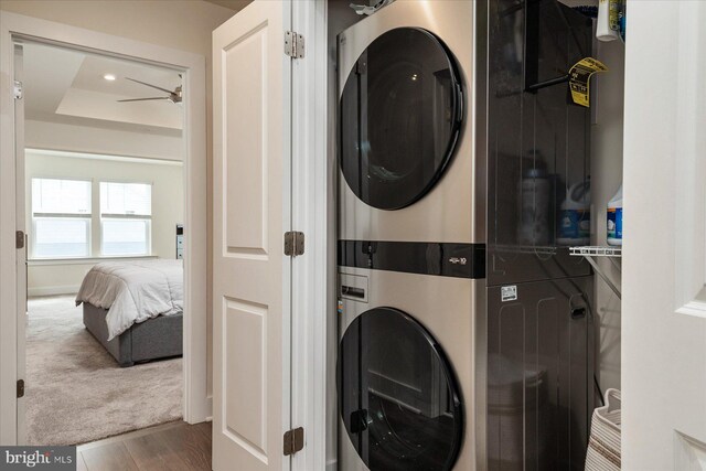 418 S Seaway Ct, Cambridge, MD 21613 - clothes washing area with stacked washer and clothes dryer and wood finished floors