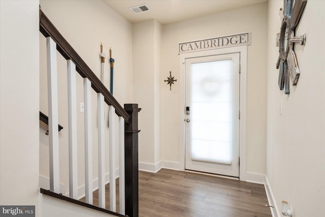 418 S Seaway Ct, Cambridge, MD 21613 - entrance foyer featuring wood finished floors, stairway, and baseboards