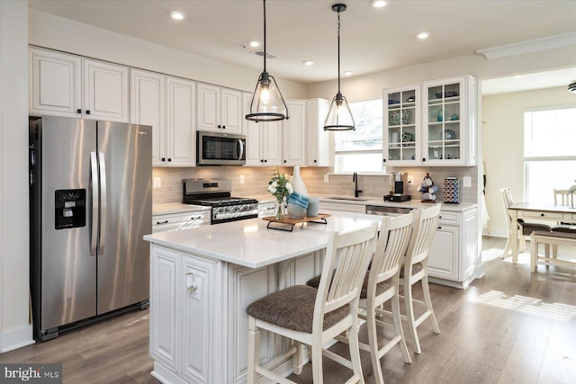418 S Seaway Ct, Cambridge, MD 21613 - kitchen featuring stainless steel appliances, white cabinetry, plenty of natural light, light wood finished floors, and recessed lighting