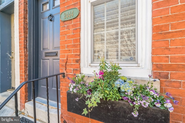 property entrance with brick siding