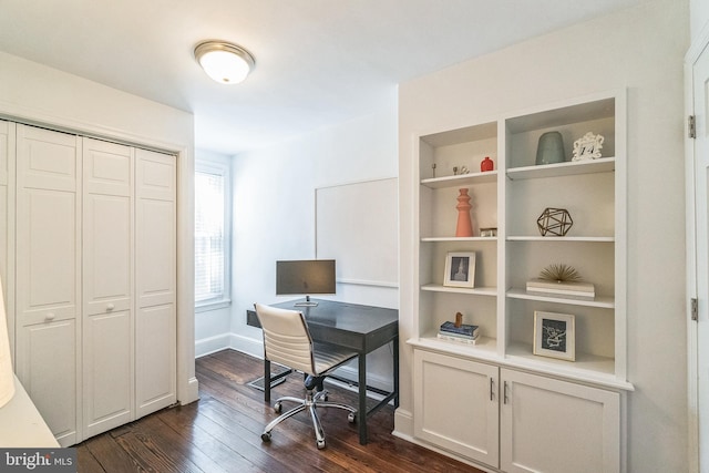 office space with dark wood-type flooring, baseboards, and built in features