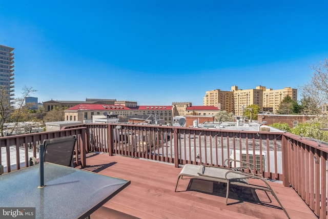 wooden deck featuring a city view
