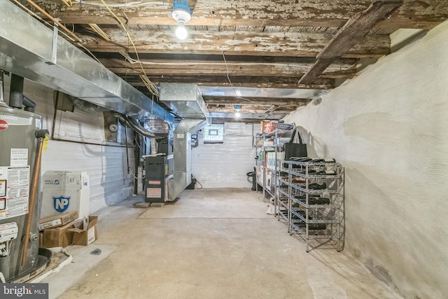 basement featuring gas water heater and heating unit