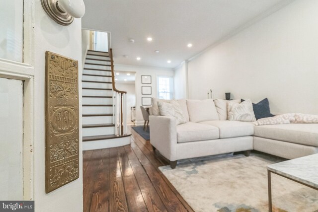 living room featuring ornamental molding, dark wood finished floors, recessed lighting, and stairs