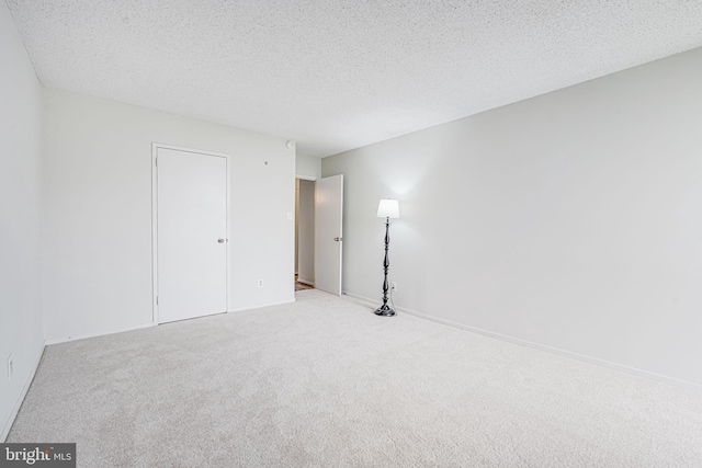 2311 Pimmit Dr Unit 1102, Falls Church, VA 22043 - unfurnished bedroom featuring carpet flooring, a textured ceiling, and baseboards